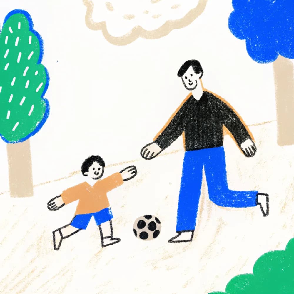 A dad and his young son playing football in the park