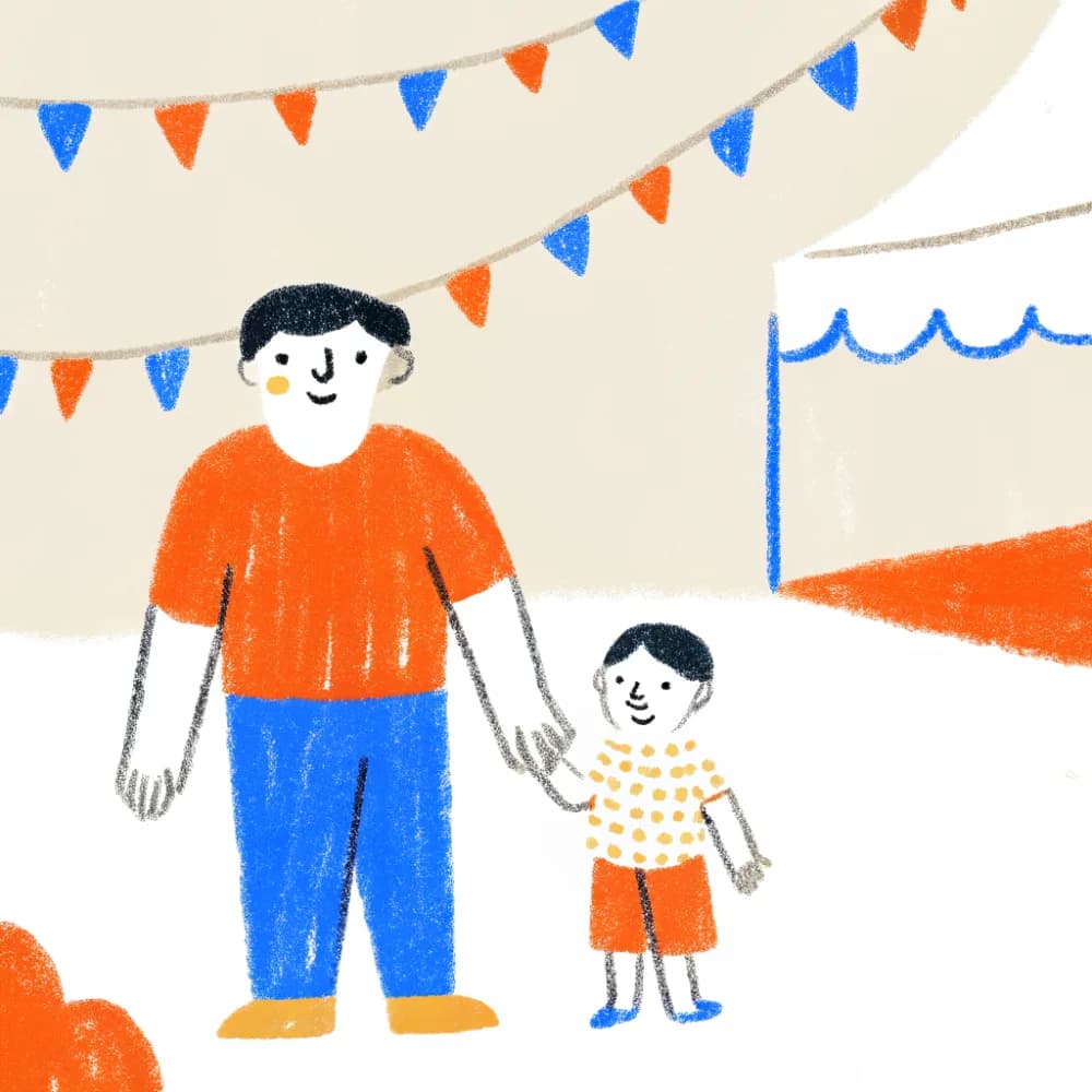 A dad and child at an outdoor festival