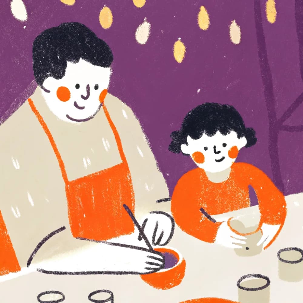 A dad and child making something together at a craft table